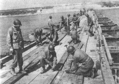 Brazilian engineers constructing a pontoon bridge