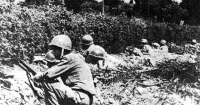 US infantry take cover in the bocage