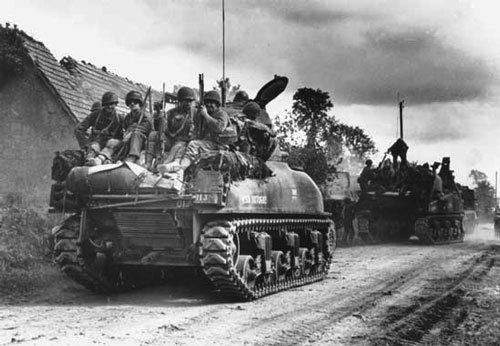 US Infantry and tanks head to the front US Infantry and tanks head to the front
