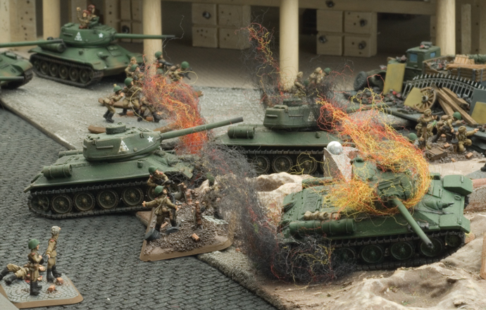 The Soviet tanks and infantry throw themselves and the Axis defenders